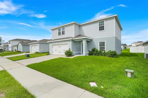 a front view of house with yard and green space
