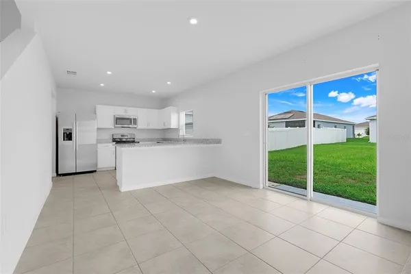 a large white kitchen with a sink and cabinets