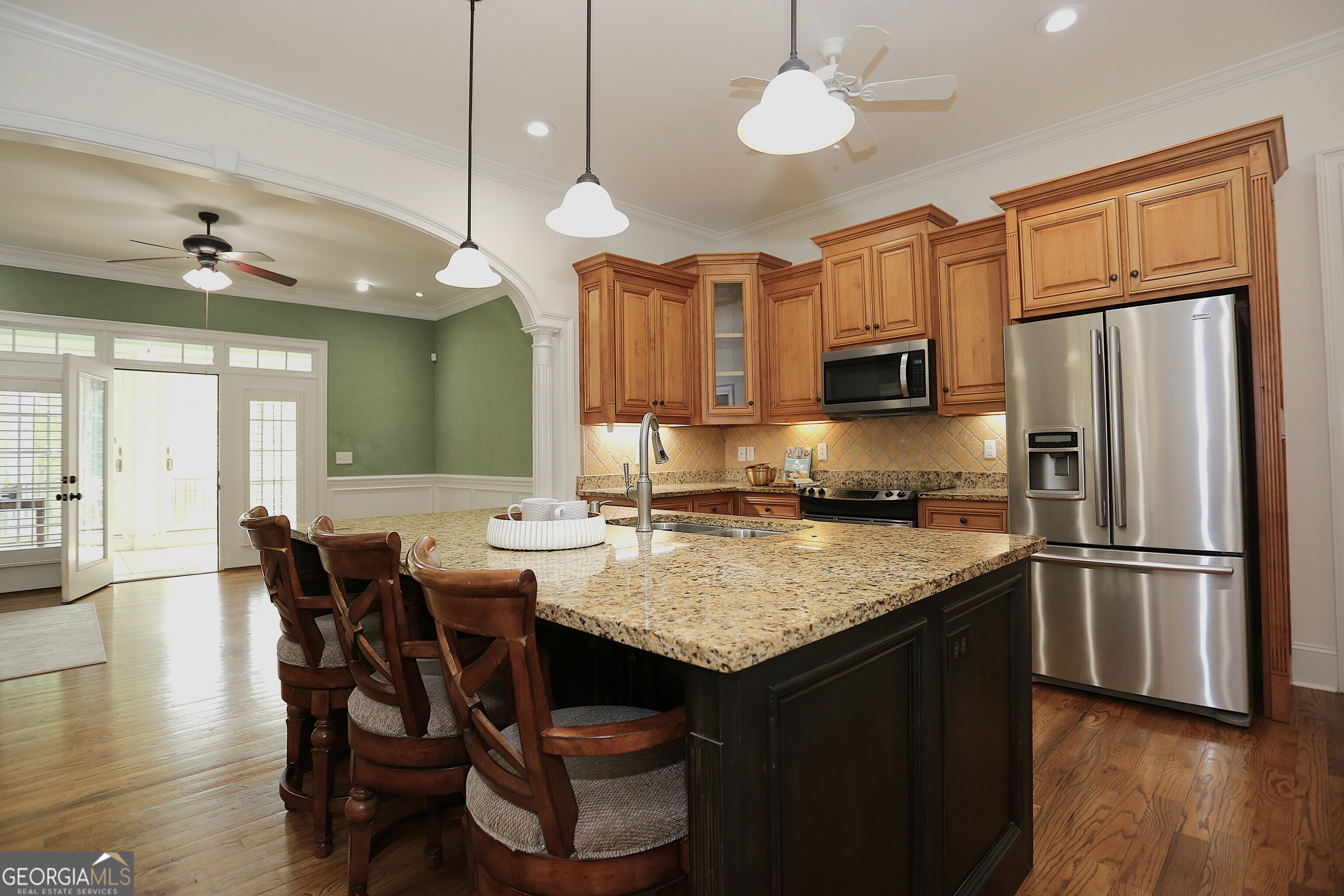 859 Tufthunter Macon, GA 31210 - Photo 15 of 94 a kitchen with stainless steel appliances granite countertop a stove a refrigerator a sink a dining table and chairs with wooden floor