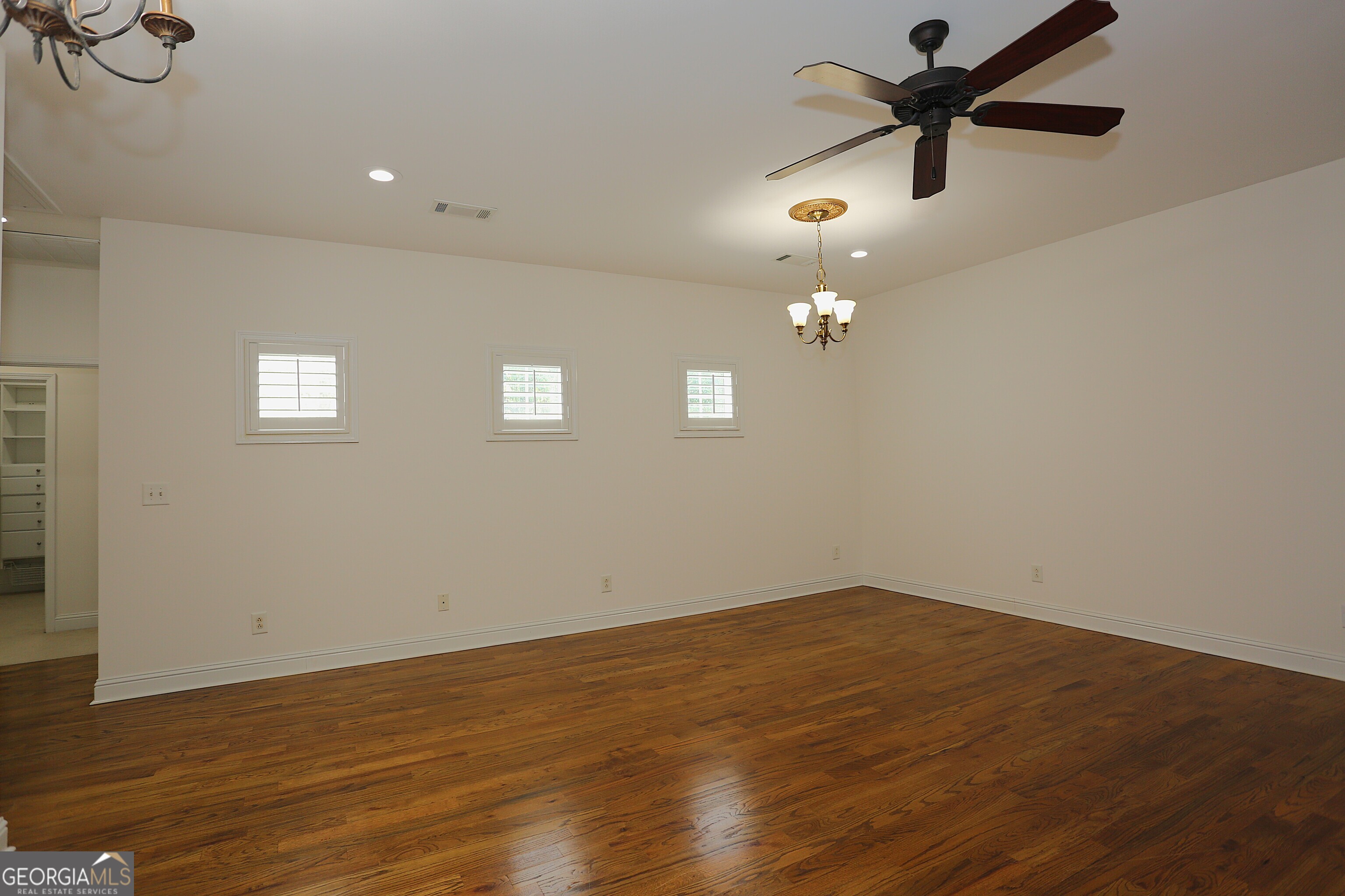 859 Tufthunter Macon, GA 31210 - Photo 42 of 94 an empty room with wooden floor and fan