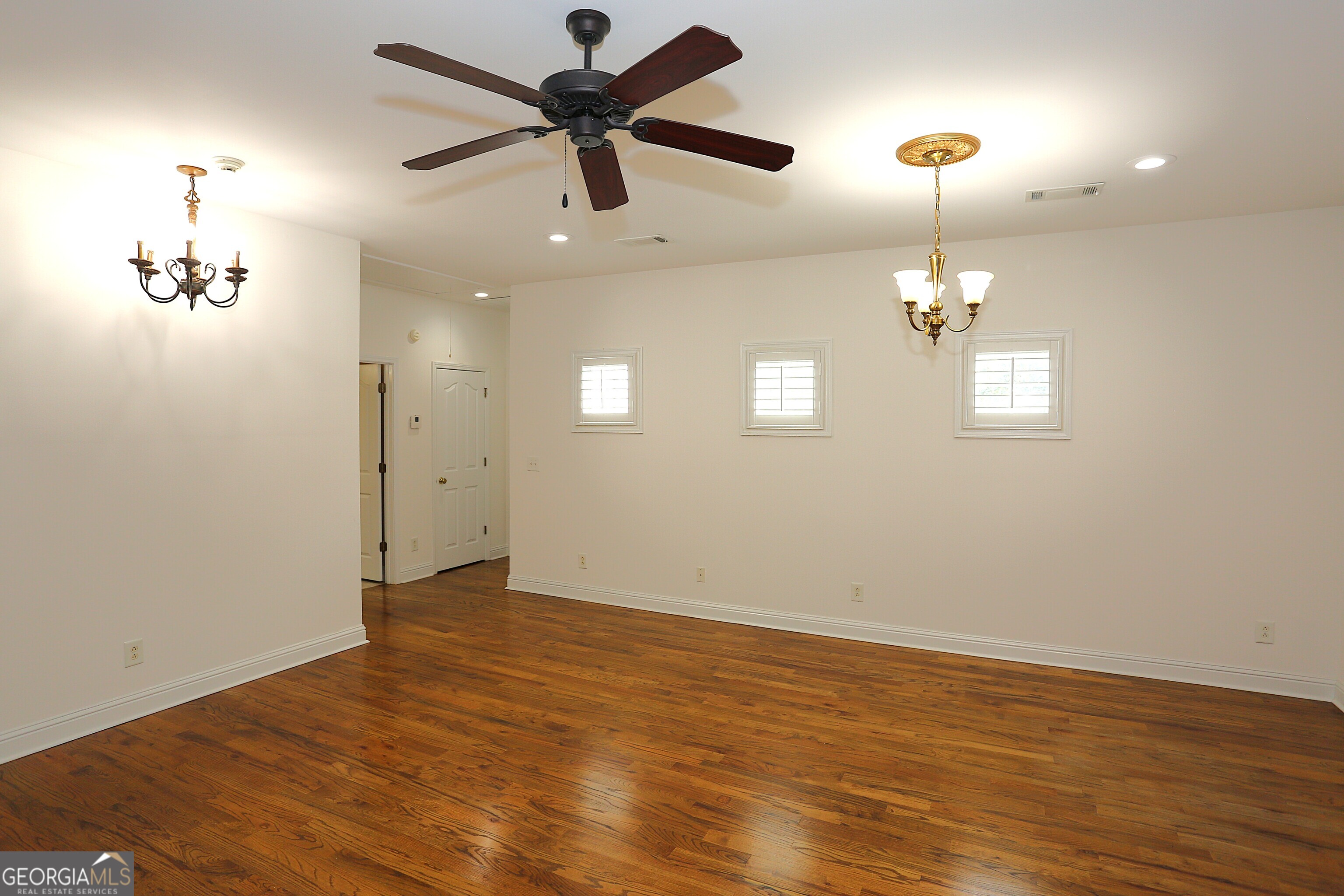 859 Tufthunter Macon, GA 31210 - Photo 43 of 94 an empty room with wooden floor fan and windows