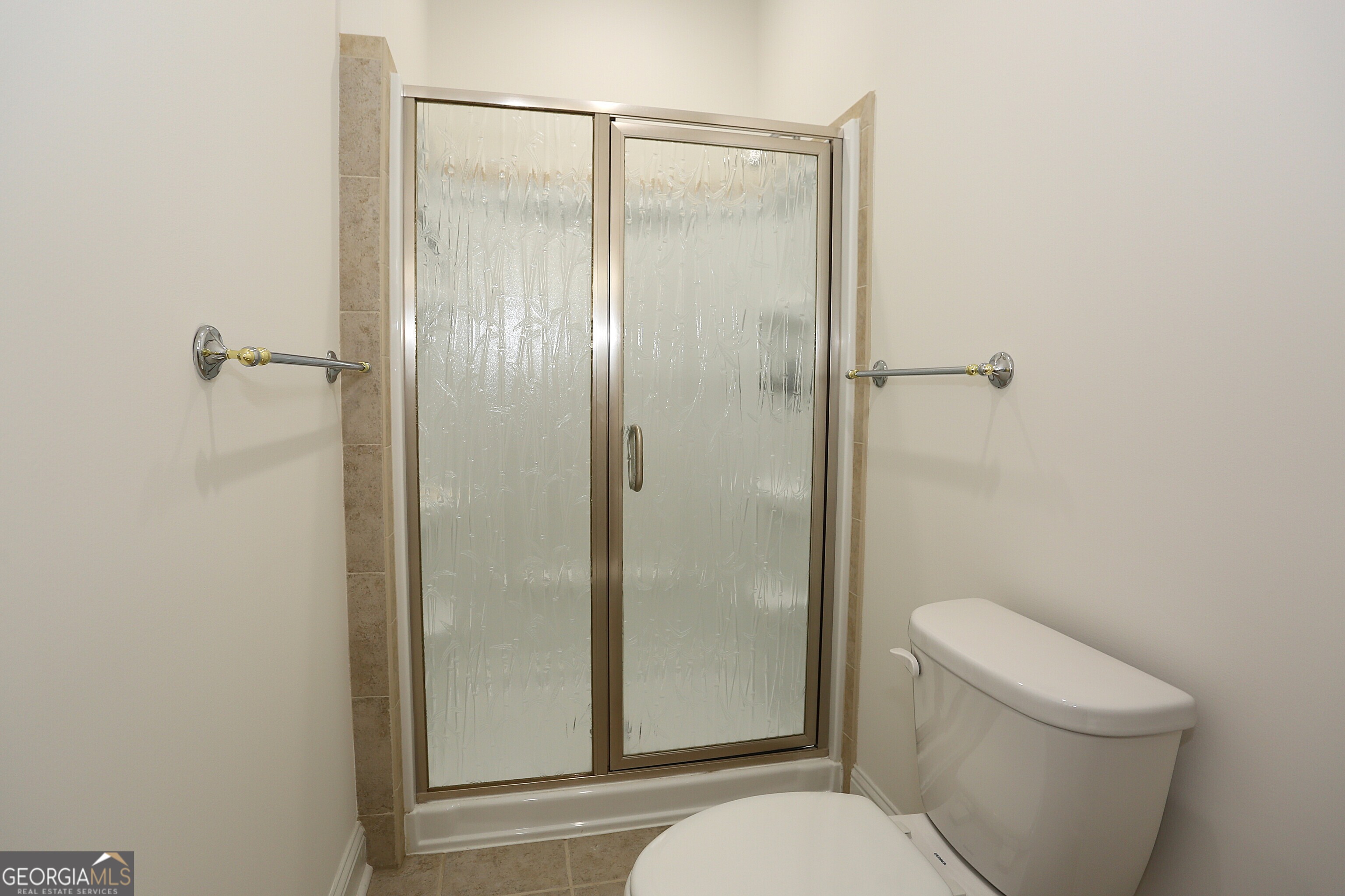 859 Tufthunter Macon, GA 31210 - Photo 49 of 94 a bathroom with a granite countertop toilet a sink and shower