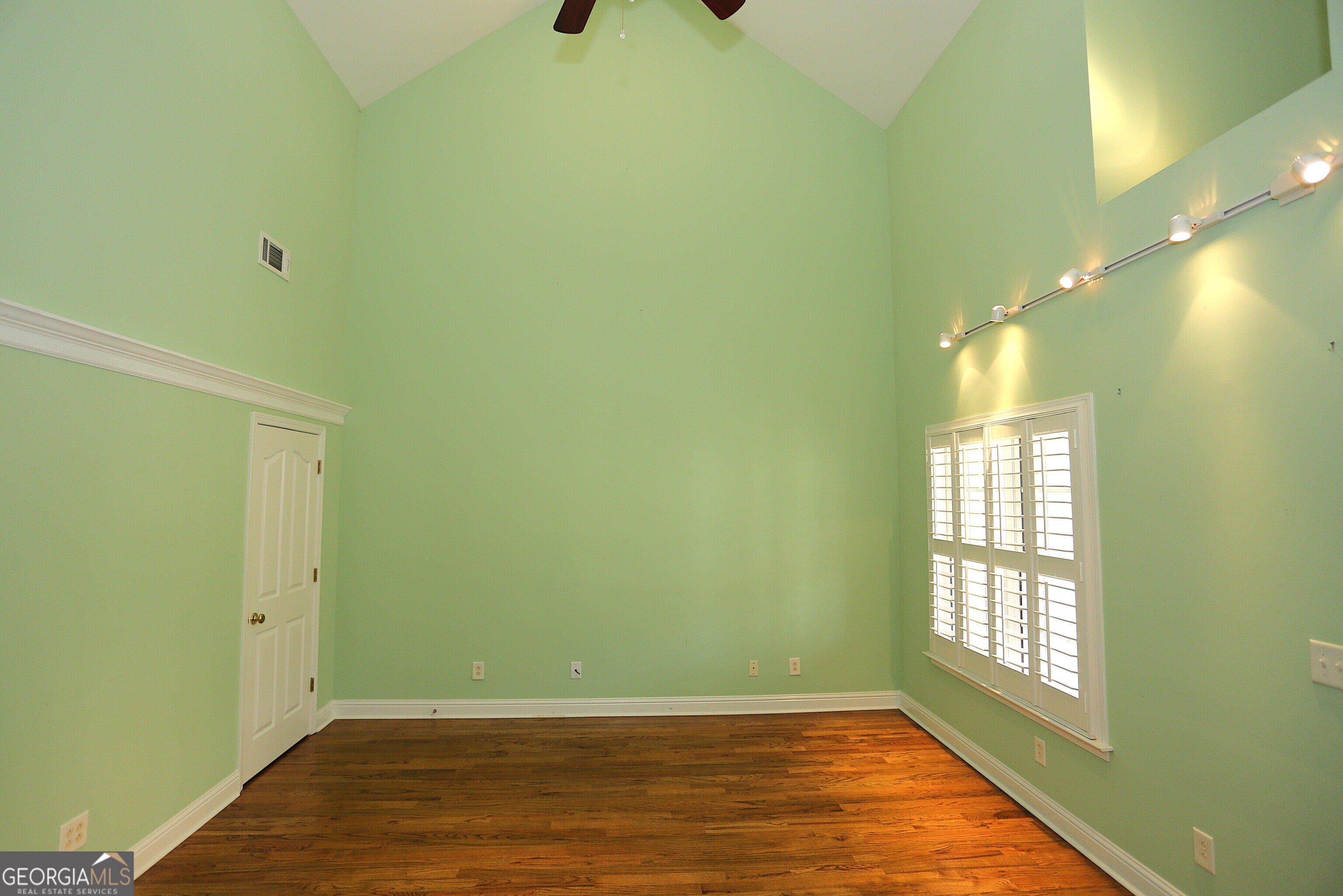 859 Tufthunter Macon, GA 31210 - Photo 52 of 94 a view of an empty room with wooden floor and a window