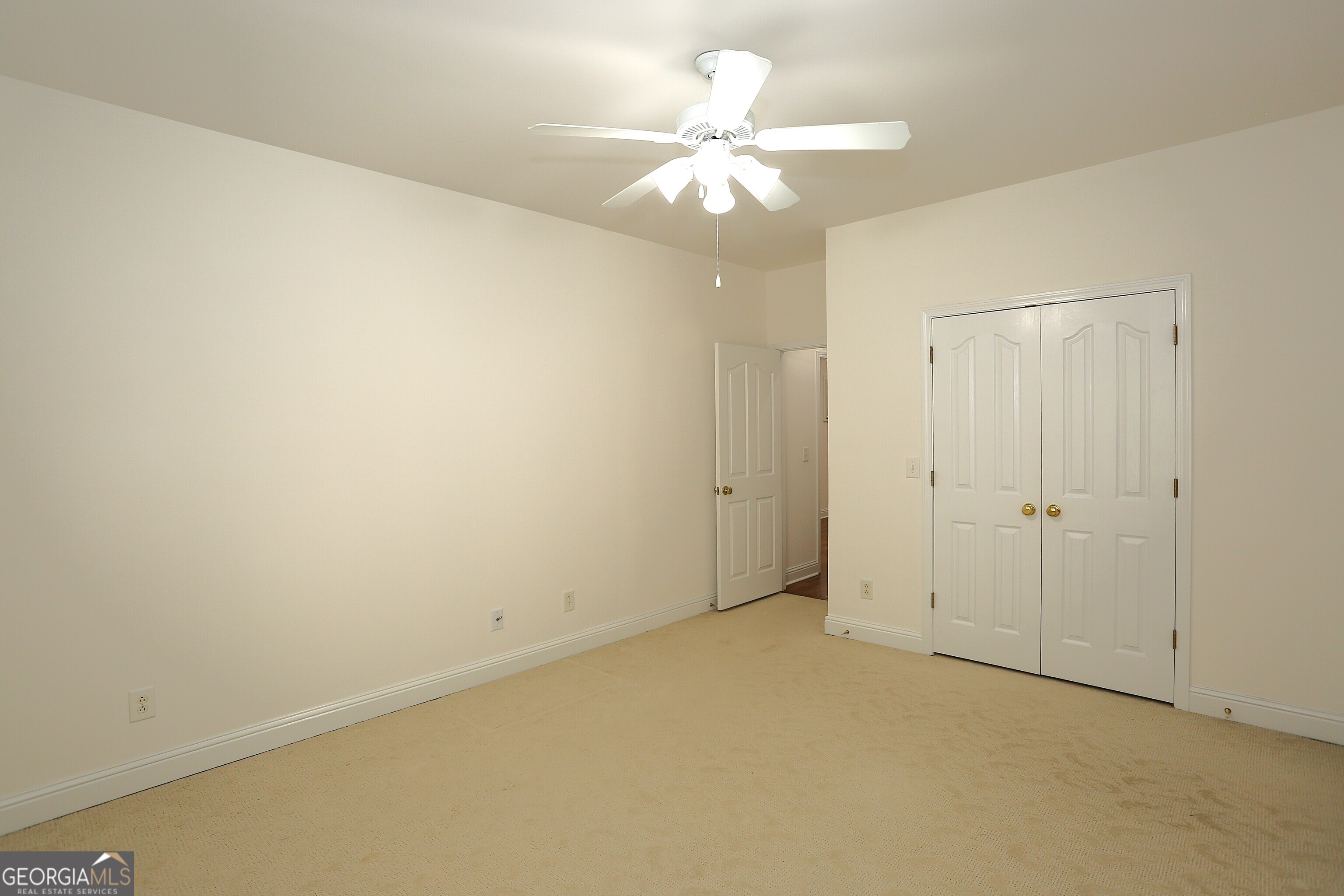 859 Tufthunter Macon, GA 31210 - Photo 63 of 94 an empty room with a chandelier fan and closet