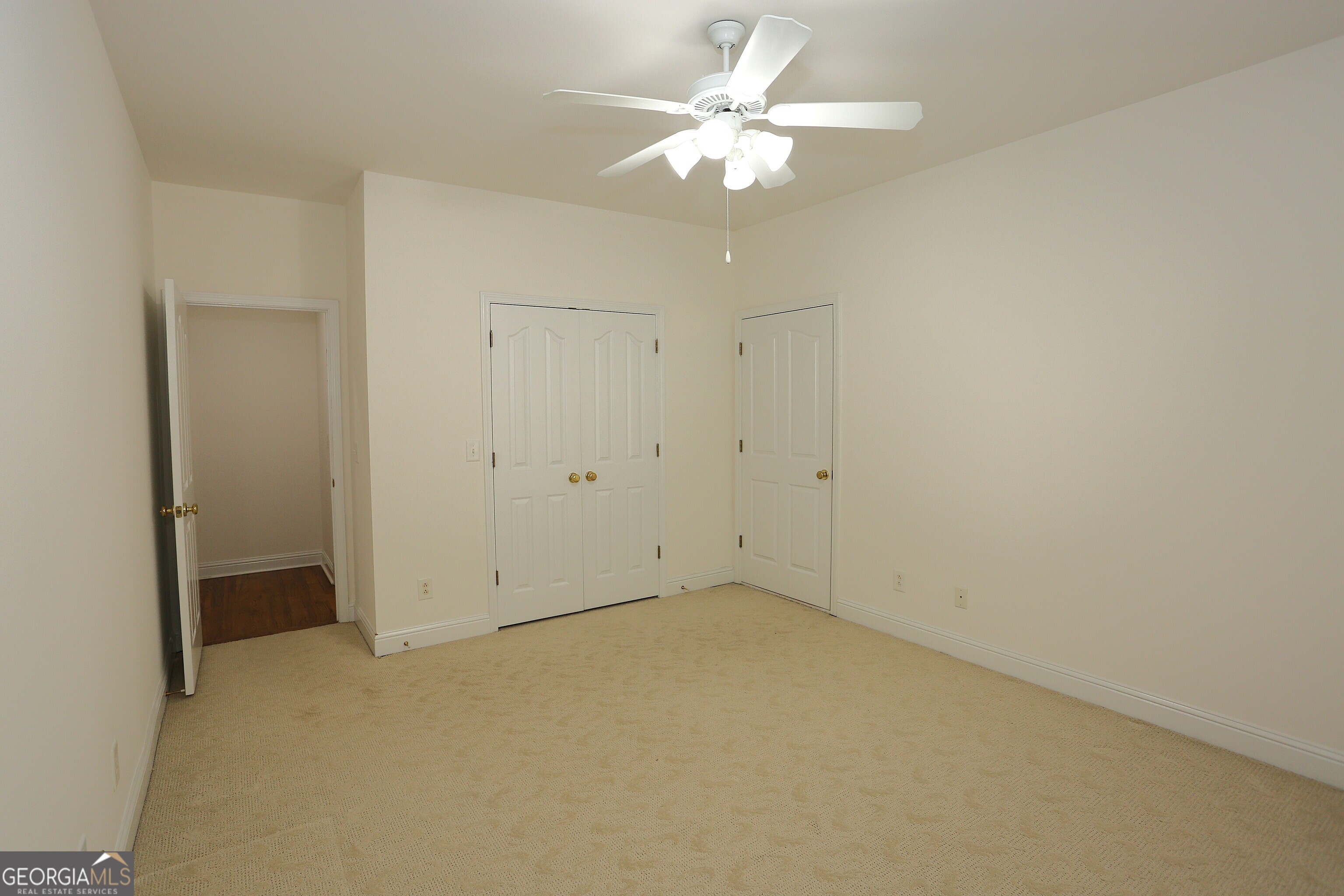 859 Tufthunter Macon, GA 31210 - Photo 64 of 94 an empty room with a chandelier fan