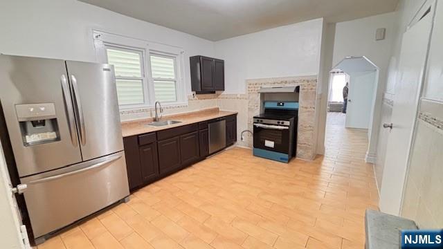 312 Hamilton Street, Unit 1 Harrison, NJ 07029 - Photo 10 of 16 a kitchen with stainless steel appliances a refrigerator stove and sink
