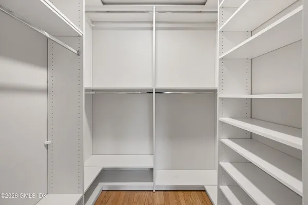 a view of walk in closet with empty racks