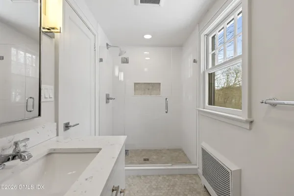 a bathroom with a sink a mirror and a bathtub
