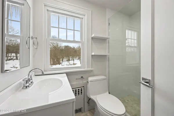 a white toilet sitting next to a bathroom sink