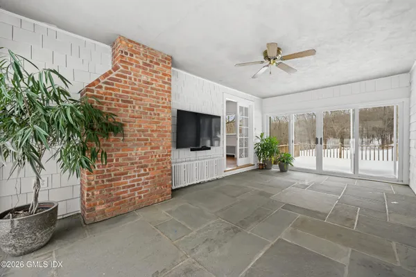 a living room with furniture a flat screen tv and a potted plant