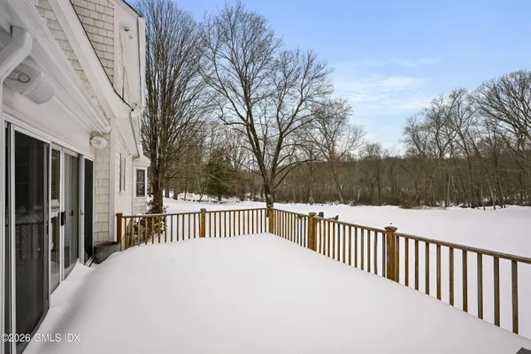 a view of a house with a wooden fence