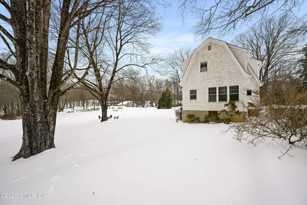 a view of a white house with a snow