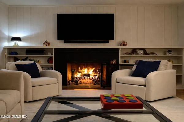 a living room with furniture a flat screen tv and a fireplace
