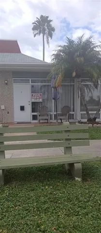 a swimming pool with trees in the background