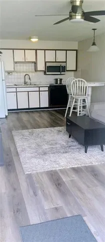 a kitchen with kitchen island a sink and stove