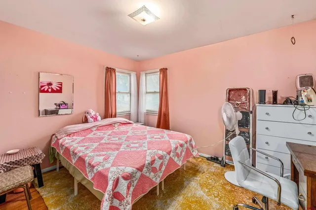 a bedroom with a bed and a dresser in it