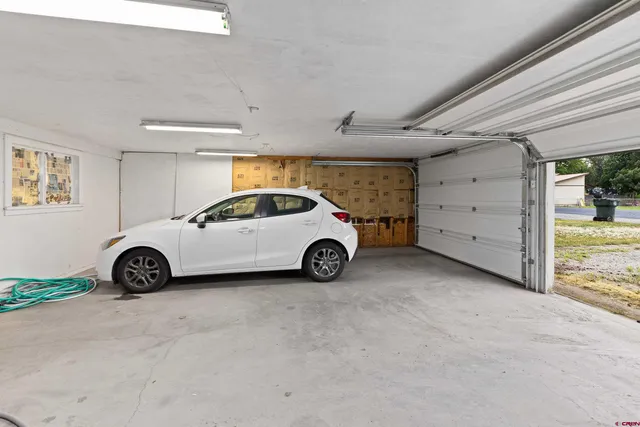 a backyard of a house with a swing table and chairs