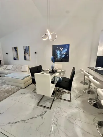 a living room with furniture a couch and a flat screen tv