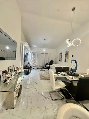 a living room with lots of furniture and view of a chandelier