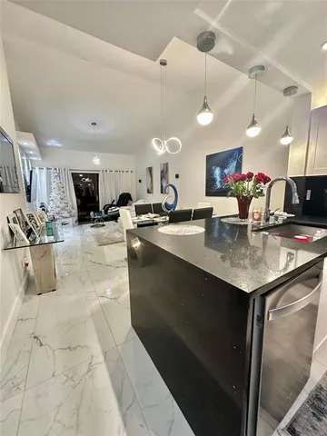 a kitchen with stainless steel appliances granite countertop a sink a stove and cabinets