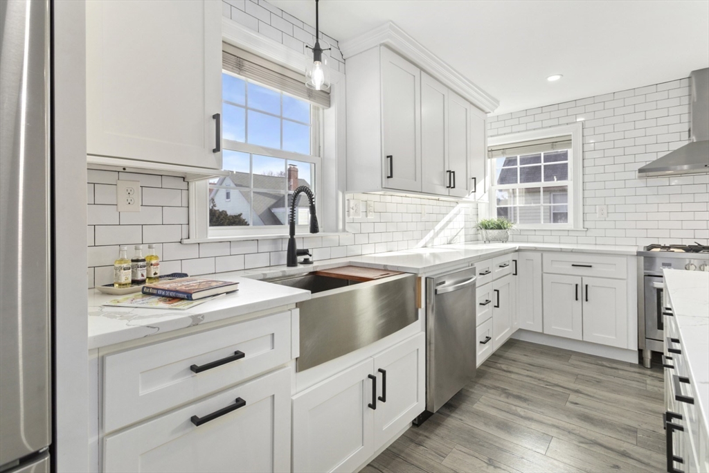 87 Otis Street, Unit 2 Medford, MA 02155 - Photo 11 of 42 a kitchen with stainless steel appliances a sink stove and cabinets