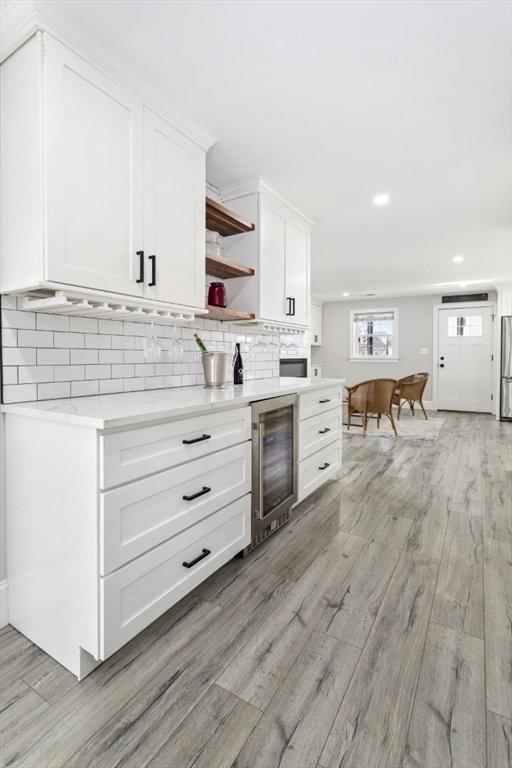87 Otis Street, Unit 2 Medford, MA 02155 - Photo 18 of 42 a kitchen with a white stove cabinets and wooden floor