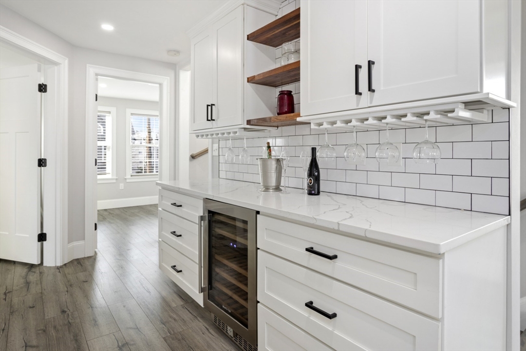 87 Otis Street, Unit 2 Medford, MA 02155 - Photo 19 of 42 a kitchen with a wooden floor and white cabinets