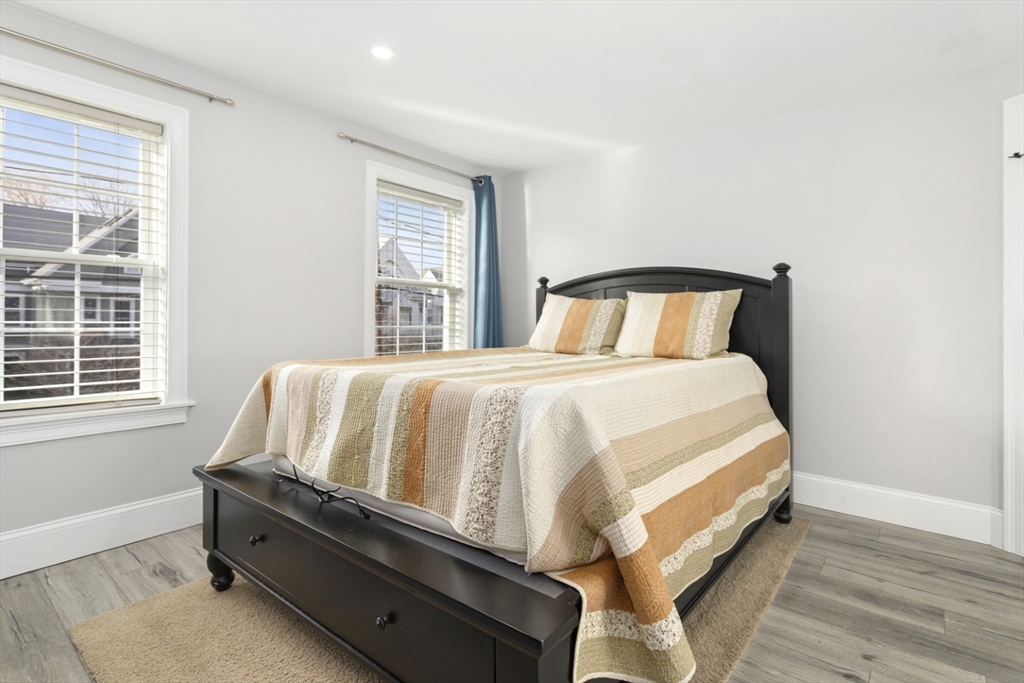 87 Otis Street, Unit 2 Medford, MA 02155 - Photo 20 of 42 a bed sitting in a bedroom next to a window
