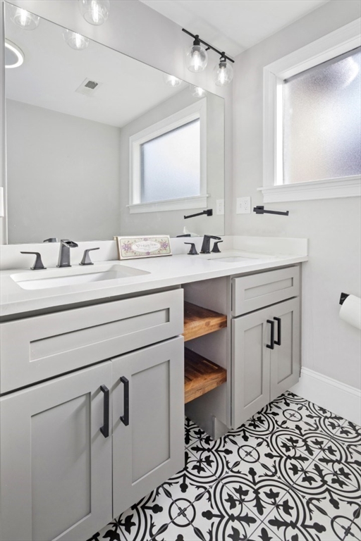 87 Otis Street, Unit 2 Medford, MA 02155 - Photo 24 of 42 a bathroom with a sink a toilet and mirror