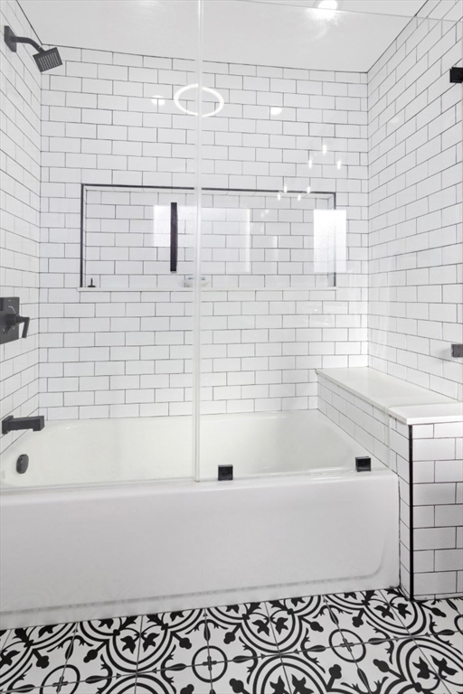 87 Otis Street, Unit 2 Medford, MA 02155 - Photo 25 of 42 a bathroom with a bathtub