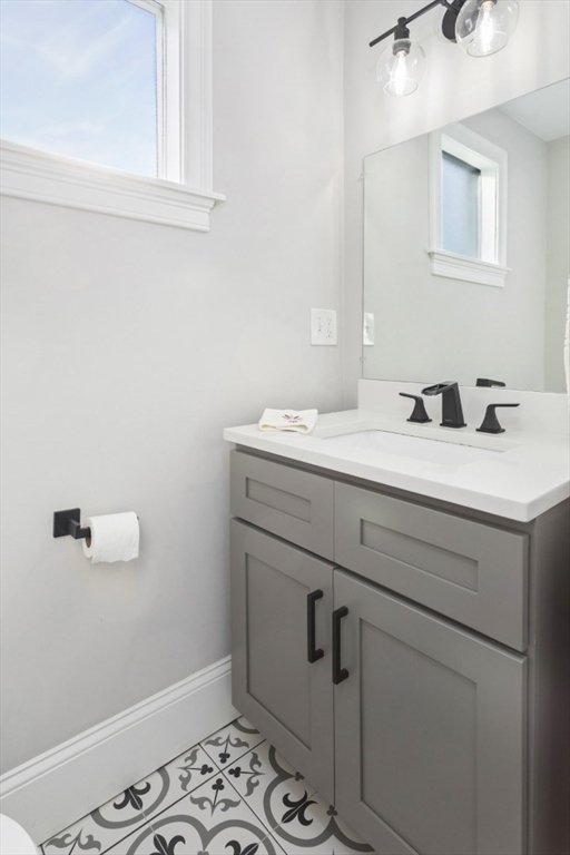 87 Otis Street, Unit 2 Medford, MA 02155 - Photo 28 of 42 a bathroom with a sink and a mirror