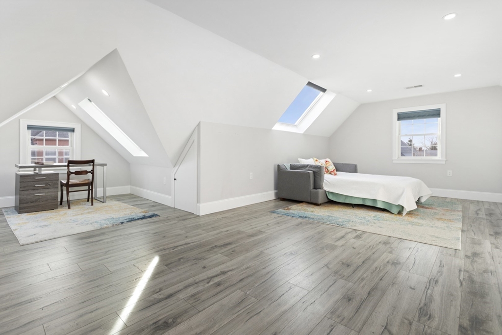 87 Otis Street, Unit 2 Medford, MA 02155 - Photo 33 of 42 a living room with furniture and a wooden floor