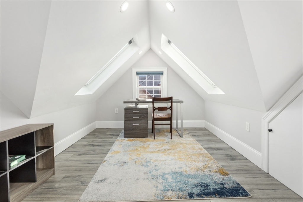 87 Otis Street, Unit 2 Medford, MA 02155 - Photo 34 of 42 a view of a kitchen with furniture and wooden floor