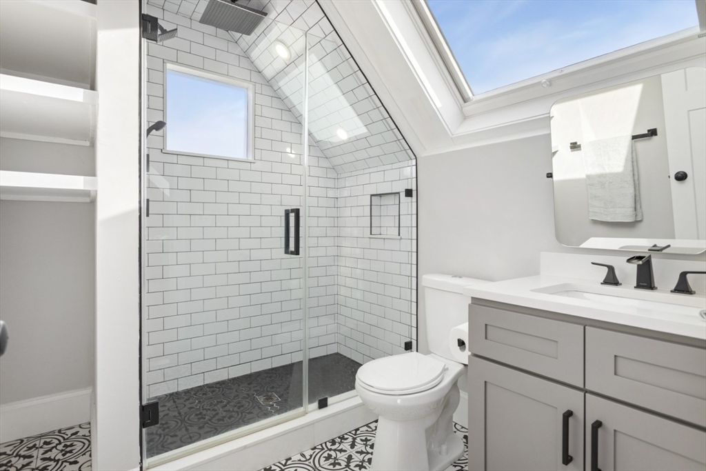 87 Otis Street, Unit 2 Medford, MA 02155 - Photo 35 of 42 a bathroom with a toilet a sink and shower