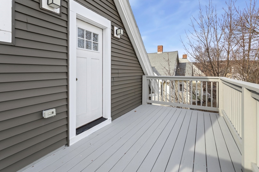 87 Otis Street, Unit 2 Medford, MA 02155 - Photo 38 of 42 a view of a balcony with wooden floor