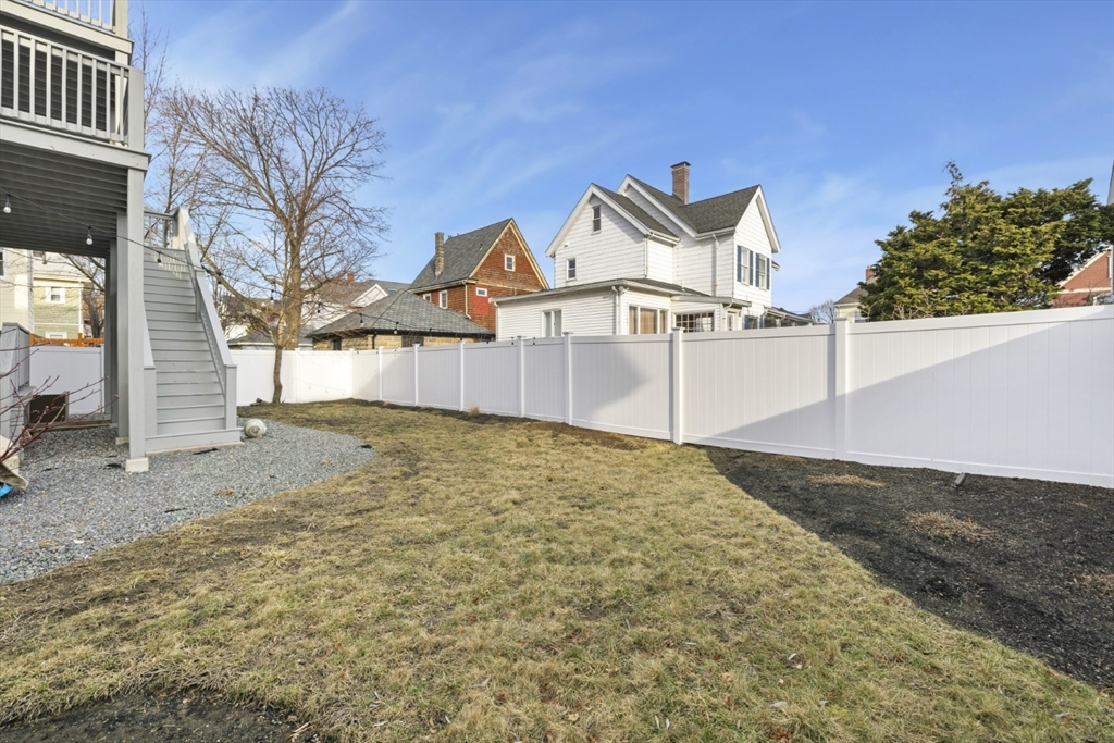 87 Otis Street, Unit 2 Medford, MA 02155 - Photo 39 of 42 a front view of a house with a yard