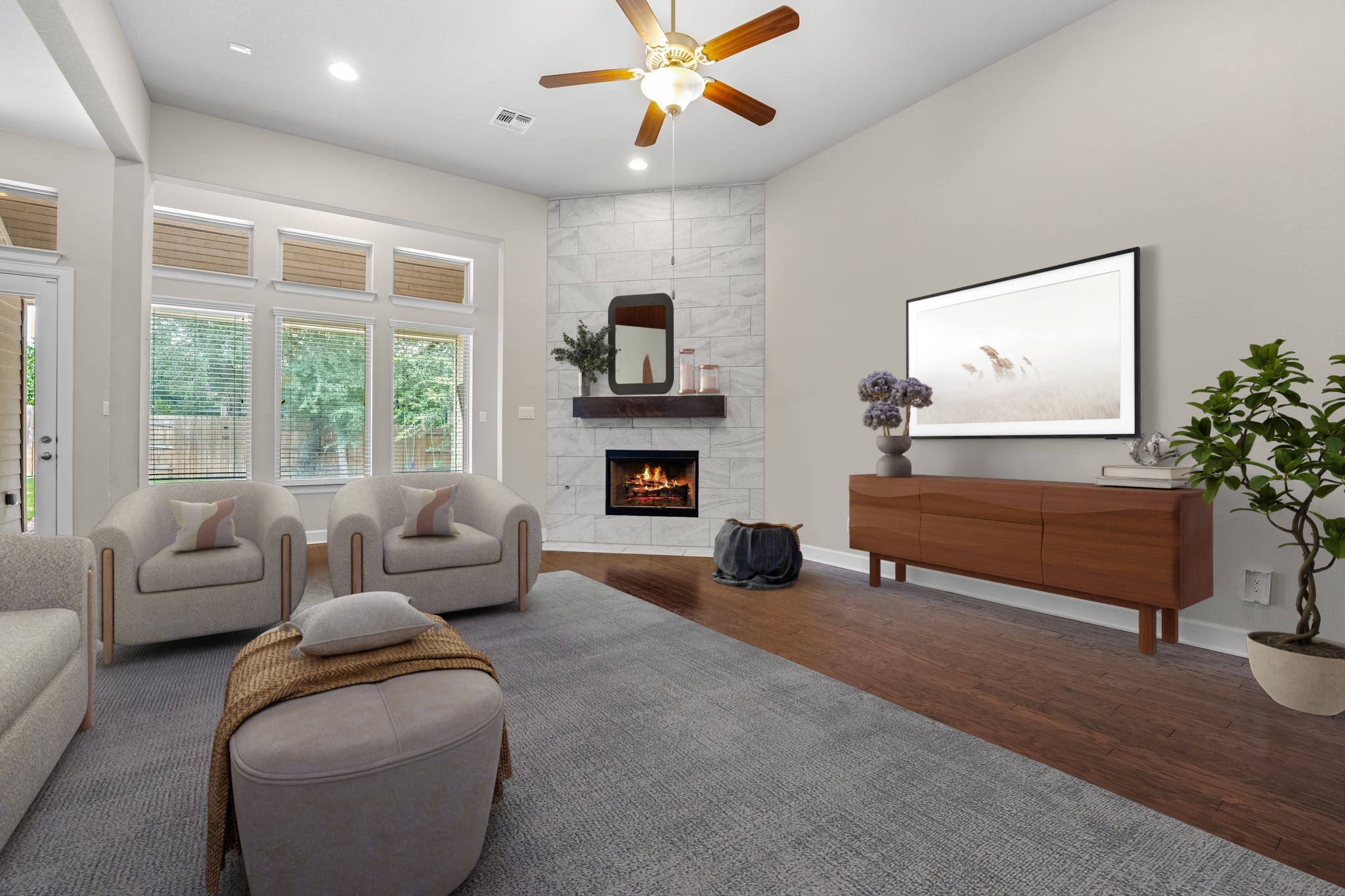 a living room with furniture a large window and a fireplace
