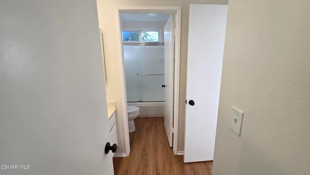 a view of a bathroom from a hallway