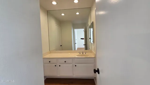 a bathroom with a sink vanity and mirror