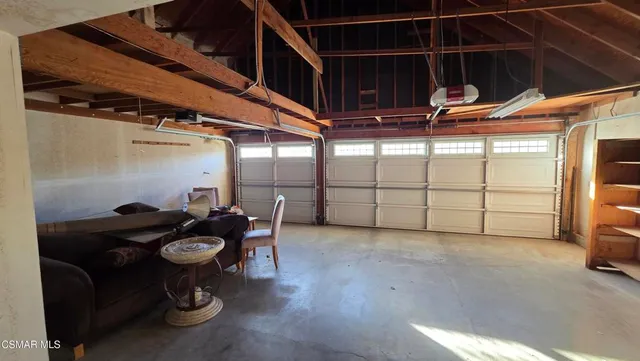 a view of a house with a yard and potted plants