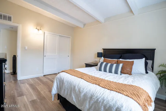 a bedroom with a bed and a night stand