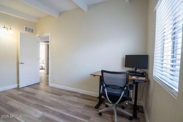 a view of workspace with wooden floor windows