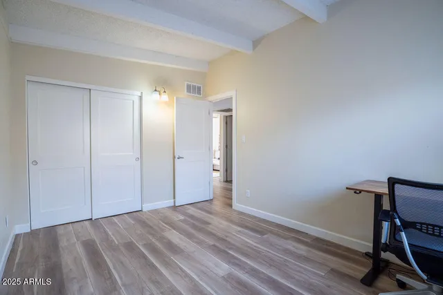a view of a room with wooden floor and bathroom