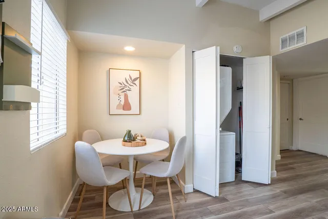 a dining room with furniture and window