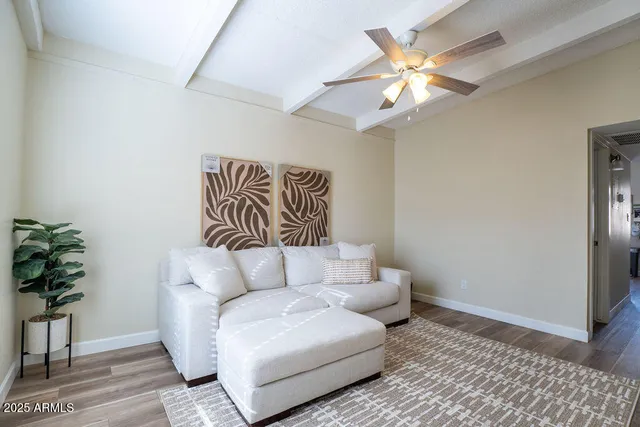 a living room with furniture and a potted plant