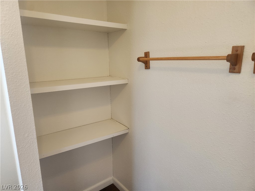 3189 Del Monte Street Laughlin, NV 89029 - Photo 18 of 32 Functional shelving and a wooden hanging rod maximize storage in this functional bathroom.