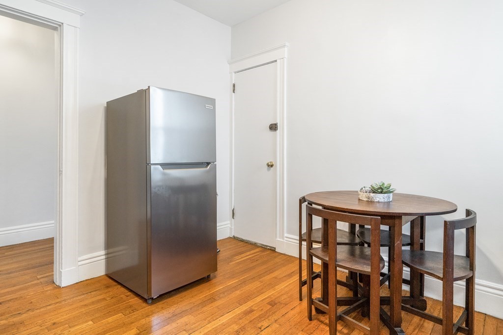 8 Kinross Road, Unit 4 Boston, MA 02135 - Photo 6 of 13 a view of a livingroom with furniture and wooden floor