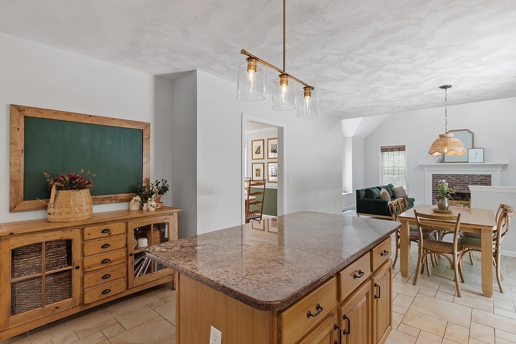40 Powder Hill Road Bolton, MA 01740 - Photo 6 of 39 a kitchen with granite countertop a table chairs and white cabinets