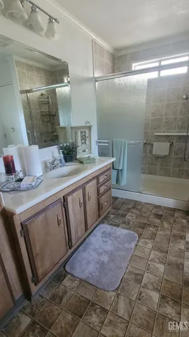 a bathroom with a granite countertop sink a toilet and shower