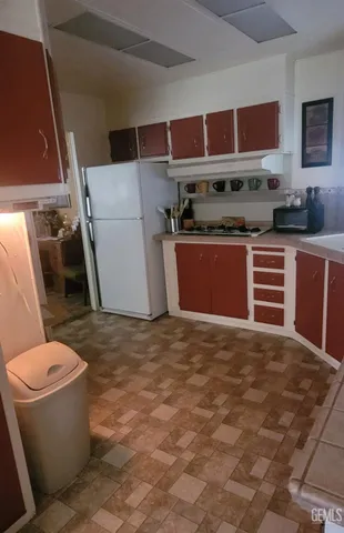 a kitchen with a stove window and cabinets